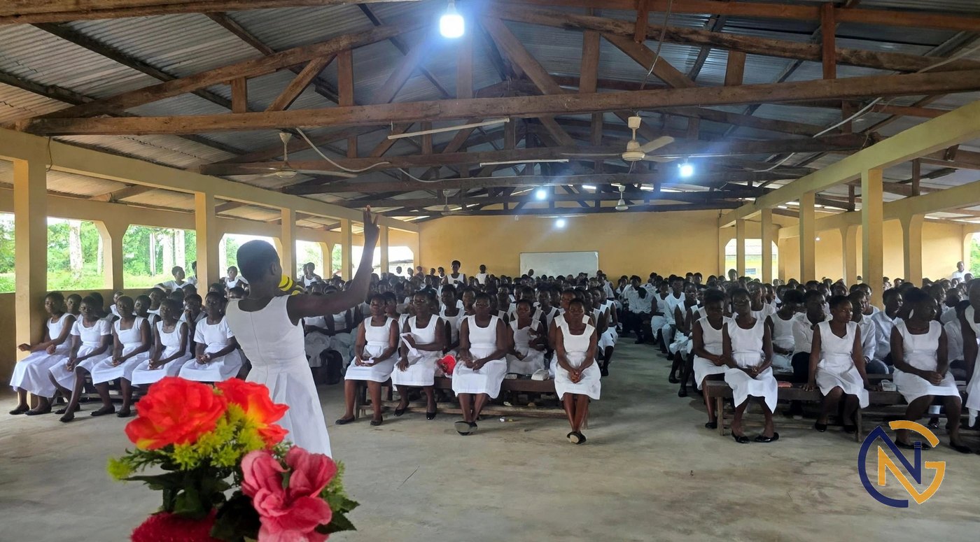 A speaker addressing students at a school assembly